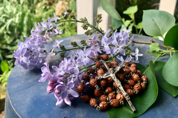 rosary next to flowers